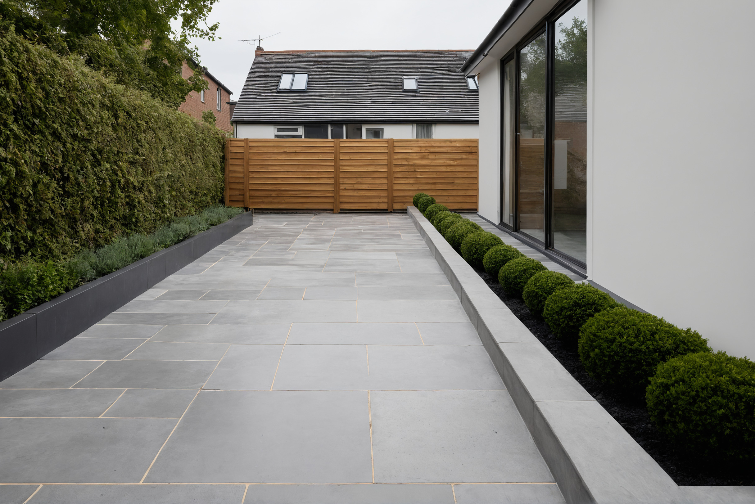 Frontage paving sloping away from the house into a linear drainage channel